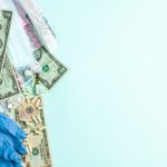 Medical items and cash scattered on a surface