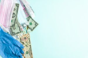 Medical items and cash scattered on a surface